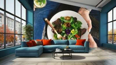 Close up woman eating salad top view Healthy food Wall mural