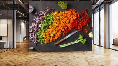 Flat lay healthy vegetarian food background. Sliced fresh vegetables on dark background. Top view Wall mural