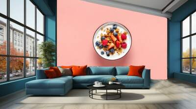 Healthy breakfast bowl with ingredients granola fruits Greek yogurt and berries on a pink background top view. Weight loss, healthy lifestyle and eating concept Wall mural