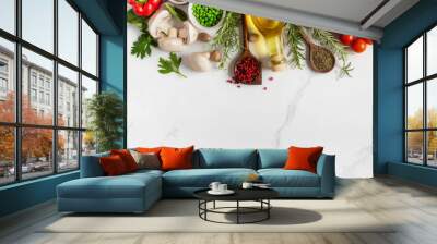 Healthy food cooking ingredients background with fresh vegetables, herbs, spices and olive oil on marble table with copy space top view Wall mural