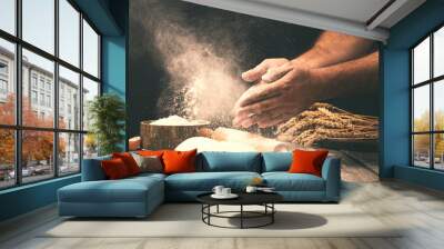 Man preparing bread dough on wooden table in a bakery Wall mural