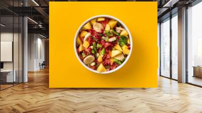 Mixed fruit salad in plate on yellow background top view Diet summer food concept Wall mural