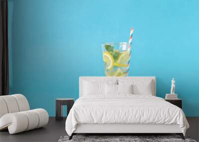 Refreshing summer cocktail with lemon and mint on blue background Wall mural