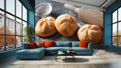 Set of fresh small bun bread on the dark table with rolling pin. Home baking concept Wall mural