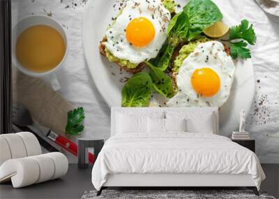 Top view healthy avocado toasts breakfast lunch fried eggs cup tea healthy breakfast Wall mural