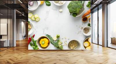 World vegan day. Frame of Fresh vegetarian ingredients for cooking vegan plate on white background overhead view Wall mural