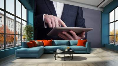 male person using a digital tablet man's hand typing text message zooming digital image on touchpad businessman using his wireless devices during a meeting work on a tablet screen Wall mural