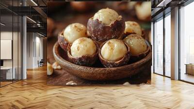 Macadamia nuts sitting in bowl on rustic wooden table Wall mural