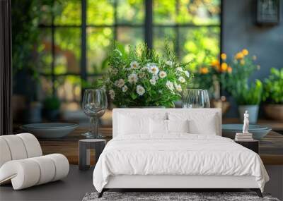 A rustic wooden table is set for a meal, with two plates, two glasses, and a vase of white flowers in the center. Wall mural