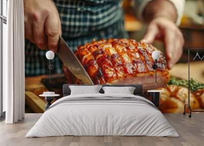 Chef carving glazed ham in kitchen with roasted garlic and rosemary garnish Wall mural