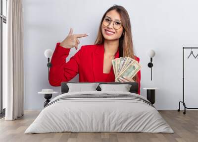 asiatic pretty woman smiling confidently pointing to own broad smile. business and banknotes concept Wall mural