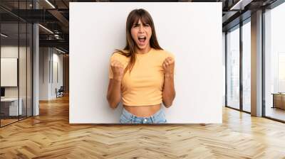 hispanic pretty woman shouting aggressively with an angry expression or with fists clenched celebrating success Wall mural