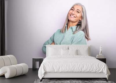 middle age gray hair woman laughing happily with arms crossed, with a relaxed, positive and satisfied pose Wall mural