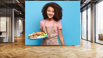 pretty afro teenager looking happy and pleasantly surprised, excited with a fascinated and shocked expression. humorous baker concept Wall mural