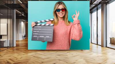 pretty blonde woman feeling happy, showing approval with okay gesture. cinema concept Wall mural