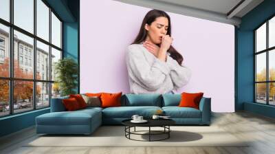 pretty young woman feeling ill with a sore throat and flu symptoms, coughing with mouth covered Wall mural