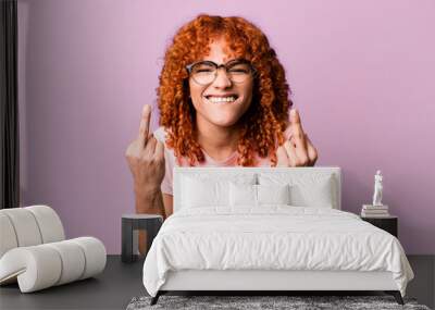 redhair pretty woman feeling provocative, aggressive and obscene, flipping the middle finger, with a rebellious attitude Wall mural