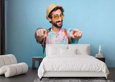 young bearded tourist man feeling happy and confident, pointing to camera with both hands and laughing, choosing you Wall mural