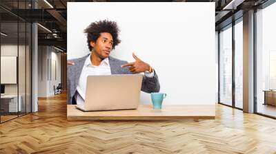 young black businessman looking proud, positive and casual pointing to chest with both hands on a desk Wall mural