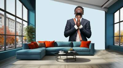 young black businessman praying in a saintly manner, begging 