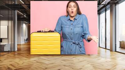 young blonde woman feeling extremely shocked and surprised, anxious and panicking, with a stressed and horrified look Wall mural