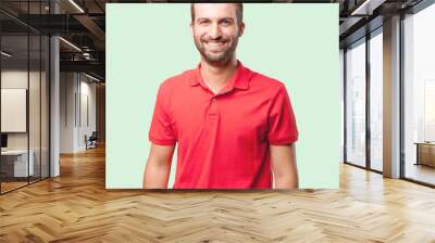 young handsome man, red polo shirt . person isolated against monochrome background Wall mural