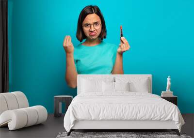 young hispanic woman making capice or money gesture, telling you to pay your debts! Wall mural