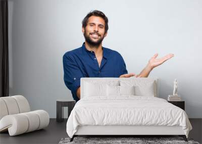 young latin handsome man smiling cheerfully giving a warm, friendly, loving welcome hug, feeling happy and adorable Wall mural