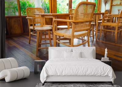 Set of brown table and chairs with weaved backrests on the brown wooden floor Wall mural