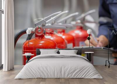 Engineer are checking and inspection a fire extinguishers tank in the fire control room for safety training and fire prevention. Wall mural