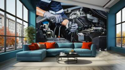 Professional mechanic working on the engine of the car in the garage. Car repair service. Wall mural