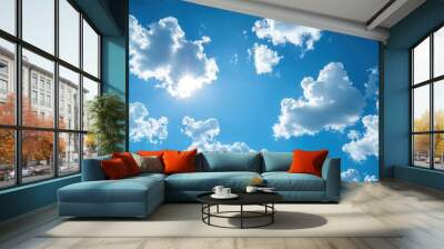 Bright blue sky adorned with fluffy white clouds, creating a serene and beautiful natural landscape. Wall mural