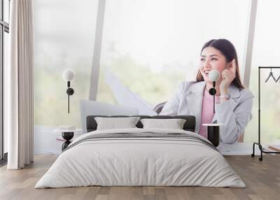 portrait of happy and smile success business woman with laptop, computer, and document on working desk Wall mural