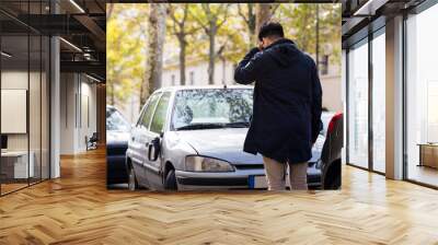 serious man stand in fron of his broken car in autumn at Paris, Wall mural