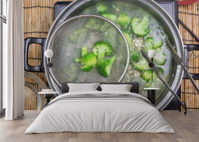 Chef boiling Broccoli in pan Wall mural