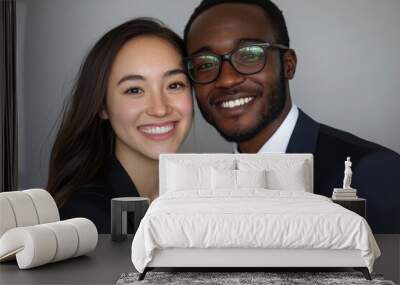 Portrait of a confident, professional, multi-ethnic business couple or partners in suits, smiling warmly at the camera in a close-up shot. Wall mural