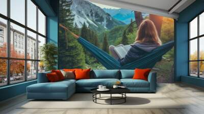 a woman relaxing in a hammock reading a book Wall mural