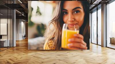 closeup of a beautiful woman drinking orange juice at home Wall mural