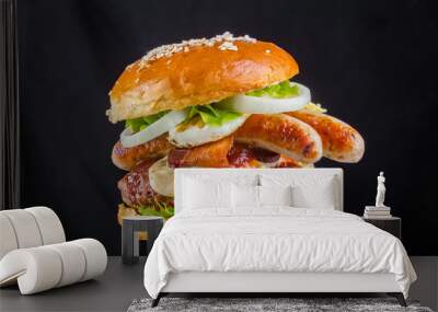 Crispy burger with bread, sausage, sausages, tomatoes sauce, flowing mozzarella melted fried yellow cheese, flakes seeds, juicy meat, pork meat steak, tomatoes, lettuce leaves, black background Wall mural