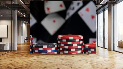 close-up, pyramid of multi-colored chips, for playing poker, on a black background and flying cards Wall mural