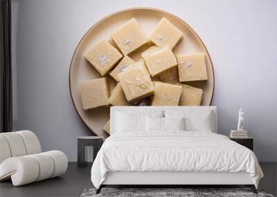 Top view of barfi in plate isolated on white background, barfi sweet made up of condense milk  Wall mural