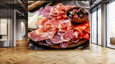 Cures meat platter with cheese and spicy olives served as traditional Spanish tapas on a wooden board. Selection of ham, salami and goat cheese Wall mural