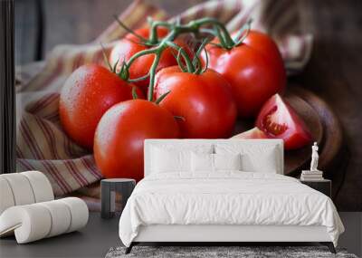 Fresh red ripe tomatoes on the vine on a dark rustic cutting board Wall mural