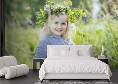 Little beautiful baby girl outdoors in a field in the fresh air happy Wall mural