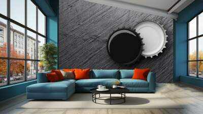 Black beer caps on dark slate background. 3D rendering. Wall mural