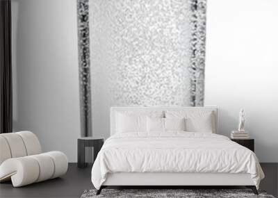 Glass of sparkling water isolated white. Wall mural