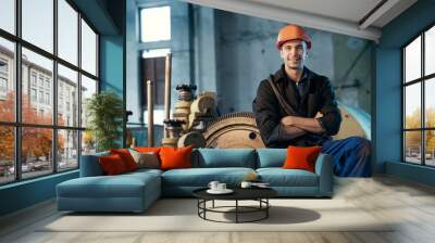 Portrait of a worker in the helmet near the steam turbine Wall mural