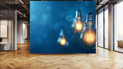 ight bulbs hanging on  blue bokeh background, light bulbs symbolizes creativity, innovation, and the power of new perspectives. Wall mural