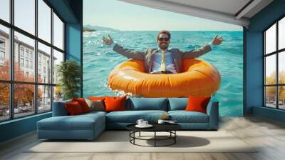 A happy man with outstretched arms on an inflatable circle in the sea. An unforgettable summer vacation with adventures. Wall mural