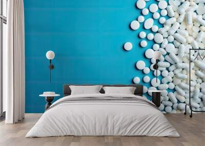 A large number of white tablets on a blue background. Wall mural